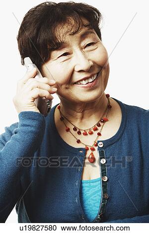 Close-up of a mature woman talking on a mobile phone View Large Photo Image Stock Image - Close-up of a mature woman talking on a mobile phone. Fotosearch