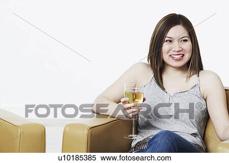 Stock Photography - Close-up of a young woman holding a wineglass. Fotosearch