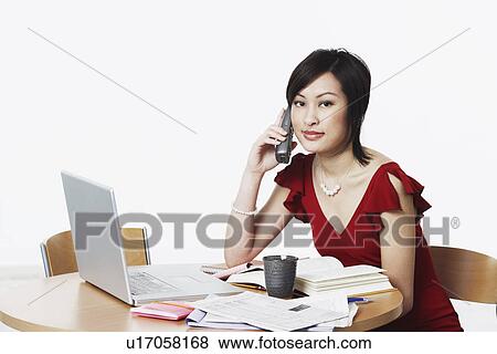 Stock Photo - Portrait of a businesswoman talking on the telephone. Fotosearch