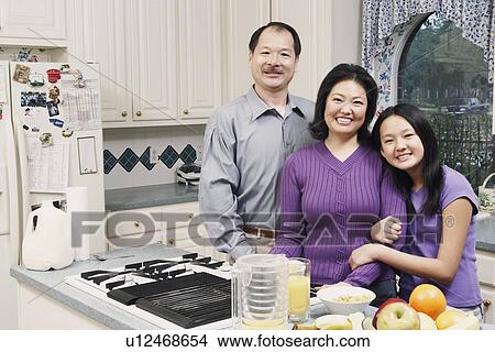 Portrait of a girl and her parents in the kitchen View Large Photo Image Picture - Portrait of a girl and her parents in the kitchen. Fotosearch