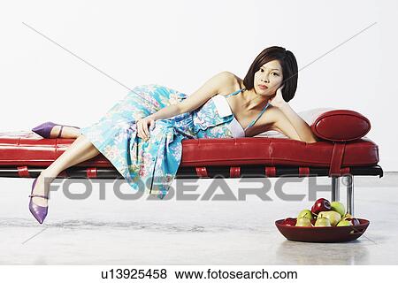 Portrait of a young woman lying down View Large Photo Image Stock Photo - Portrait of a young woman lying down. Fotosearch