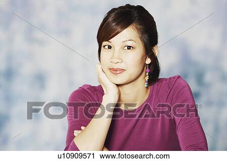 Portrait of a young woman smiling View Large Photo Image Stock Image - Portrait of a young woman smiling. Fotosearch