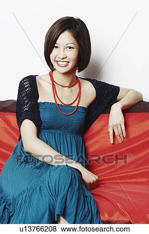 Portrait of a young woman smiling View Large Photo Image Stock Photo - Portrait of a young woman smiling. Fotosearch