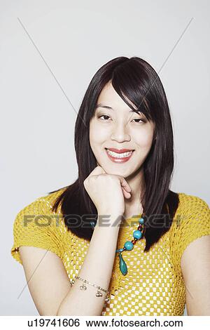 Stock Photograph - Portrait of a young woman smiling. Fotosearch