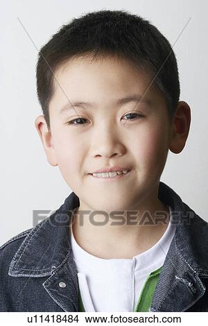Portrait of a boy biting his lips View Large Photo Image Picture - Portrait of a boy biting his lips. Fotosearch