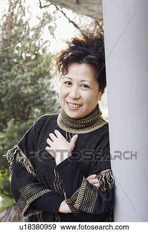 Portrait of a mature woman smiling View Large Photo Image Stock Photo - Portrait of a mature woman smiling. Fotosearch