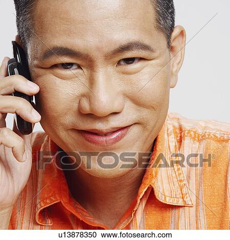 Portrait of a mid adult man using a mobile phone View Large Photo Image Stock Image - Portrait of a mid adult man using a mobile phone. Fotosearch