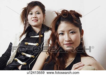 Portrait of a teenage girl and a young woman smiling View Large Photo Image Stock Photo - Portrait of a teenage girl and a young woman smiling. Fotosearch