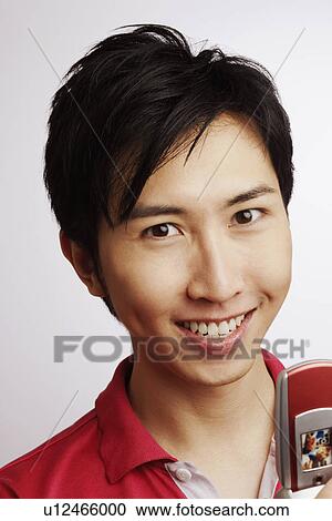 Stock Image - Portrait of a young man smiling. Fotosearch