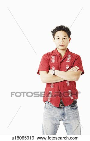 Portrait of a young man standing with his arms crossed View Large Photo Image Stock Photo - Portrait of a young man standing with his arms crossed. Fotosearch
