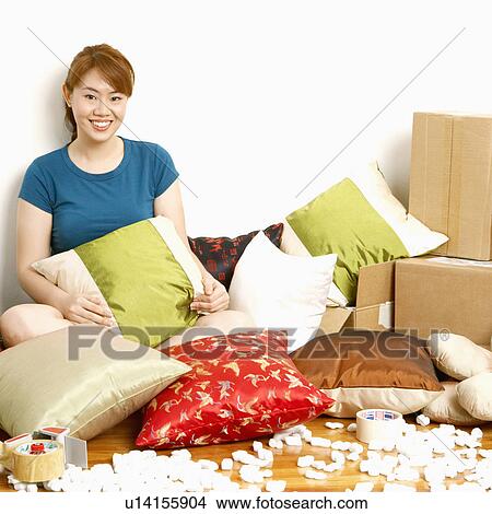 Portrait of a young woman sitting on the floor and smiling View Large Photo Image Picture - Portrait of a young woman sitting on the floor and smiling. Fotosearch