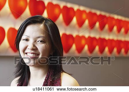 Stock Image - Portrait of a young woman smiling. Fotosearch