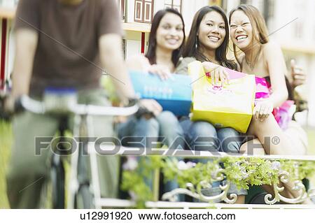 Portrait of three young women holding shopping bags View Large Photo Image Stock Image - Portrait of three young women holding shopping bags. Fotosearch