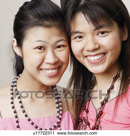 Portrait of two young women smiling View Large Photo Image Stock Image - Portrait of two young women smiling. Fotosearch