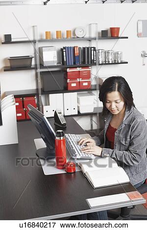 Stock Photo - High angle view of a businesswoman using a computer. Fotosearch