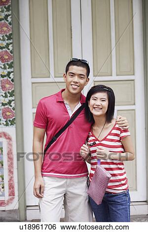 Portrait of a young couple standing on a porch View Large Photo Image Stock Photograph - Portrait of a young couple standing on a porch. Fotosearch