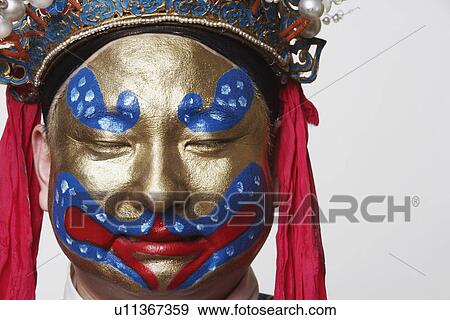 Stock Photo - Close-up of a male Chinese opera performer with his eyes closed. Fotosearch