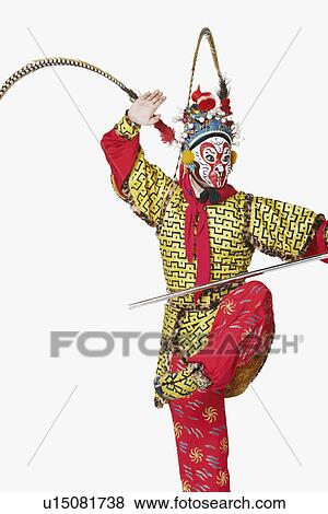 Close-up of a male Chinese opera performer gesturing with a weapon View Large Photo Image Stock Photo - Close-up of a male Chinese opera performer gesturing with a weapon. Fotosearch
