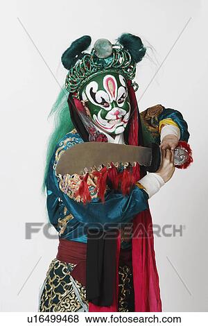 Stock Photo - Close-up of a male Chinese opera performer holding a sword. Fotosearch