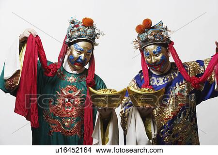 Close-up of two male Chinese opera performers holding bowls full of gold coins View Large Photo Image Picture - Close-up of two male Chinese opera performers holding bowls full of gold coins. Fotosearch