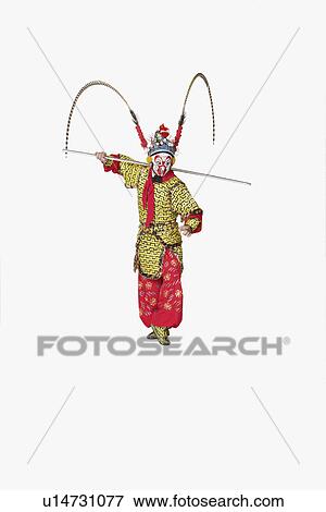 Stock Photo - Male Chinese opera performer gesturing with a weapon. Fotosearch