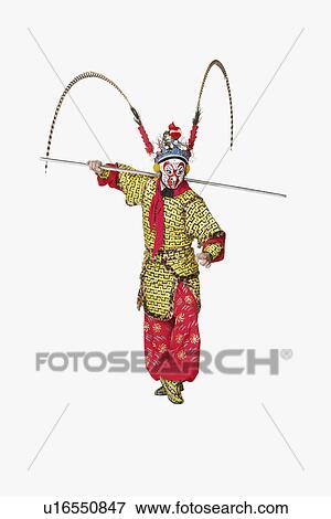 Stock Photo - Male Chinese opera performer gesturing with a weapon. Fotosearch