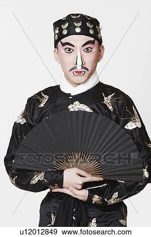 Portrait of a male Chinese opera performer holding a fan View Large Photo Image Stock Photo - Portrait of a male Chinese opera performer holding a fan. Fotosearch