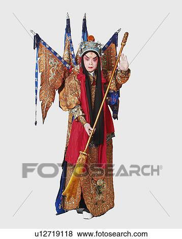 Stock Photo - Portrait of a male Chinese opera performer holding a weapon. Fotosearch