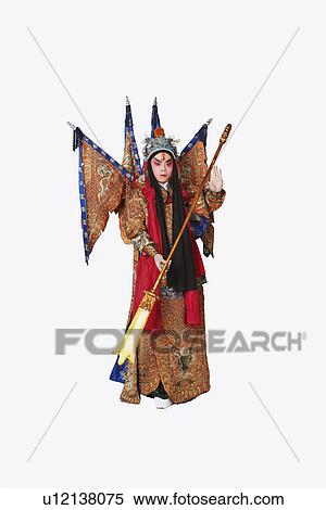 Stock Photography - Portrait of a male Chinese opera performer holding a weapon. Fotosearch