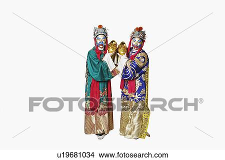 Picture - Portrait of two male Chinese opera performers holding bowls full of gold coins. Fotosearch