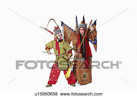 Stock Photo - Two male Chinese opera performers gesturing with weapons. Fotosearch