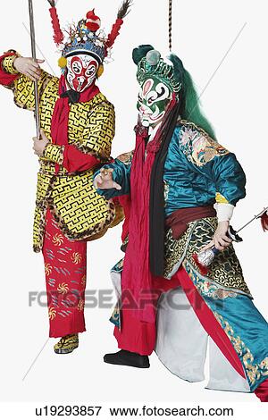 Stock Photo - Two male Chinese opera performers gesturing with weapons. Fotosearch