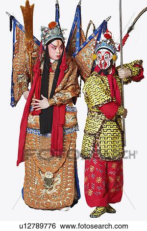 Stock Photograph - Two male Chinese opera performers gesturing with weapons. Fotosearch