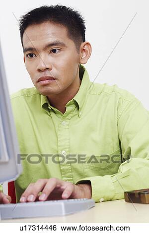 Stock Photograph - Close-up of a businessman using a computer. Fotosearch