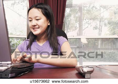 Close-up of a girl using a laptop View Large Photo Image Stock Image - Close-up of a girl using a laptop. Fotosearch