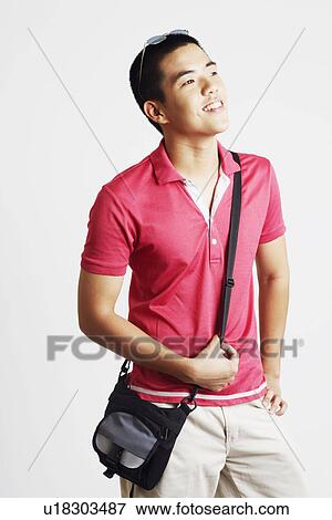Close-up of a young man smiling View Large Photo Image Stock Photo - Close-up of a young man smiling. Fotosearch