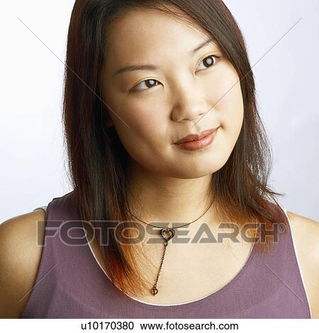 Close-up of a young woman looking sideways View Large Photo Image Stock Image - Close-up of a young woman looking sideways. Fotosearch