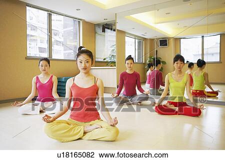 Four young women sitting in the lotus position View Large Photo Image Stock Image - Four young women sitting in the lotus position. Fotosearch
