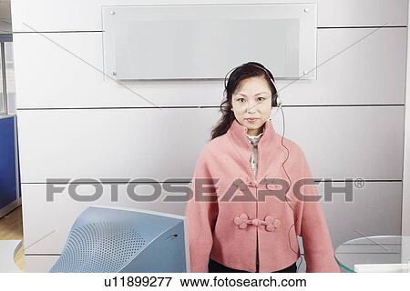 Portrait of a customer service representative standing in an office View Large Photo Image Stock Photo - Portrait of a customer service representative standing in an office. Fotosearch