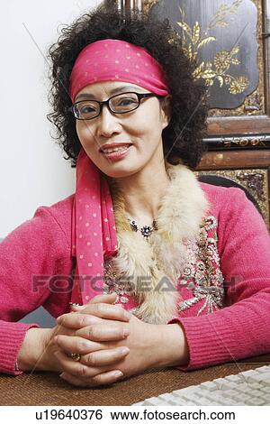 Portrait of a mature woman smiling View Large Photo Image Stock Photograph - Portrait of a mature woman smiling. Fotosearch