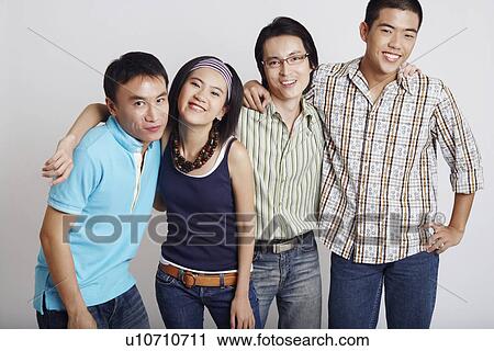 Portrait of a young couple standing with two mid adult men View Large Photo Image Stock Image - Portrait of a young couple standing with two mid adult men. Fotosearch