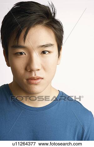Stock Photo - Portrait of a young man thinking. Fotosearch