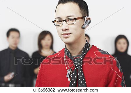 Portrait of a young man using a hands free device View Large Photo Image Stock Image - Portrait of a young man using a hands free device. Fotosearch