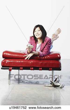 Portrait of a young woman holding a digital camera View Large Photo Image Stock Image - Portrait of a young woman holding a digital camera. Fotosearch