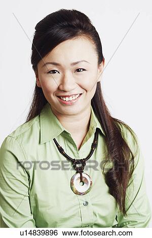 Portrait of a young woman smiling View Large Photo Image Stock Photograph - Portrait of a young woman smiling. Fotosearch
