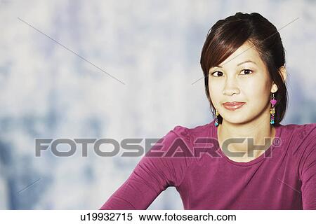Stock Photography - Portrait of a young woman smiling. Fotosearch