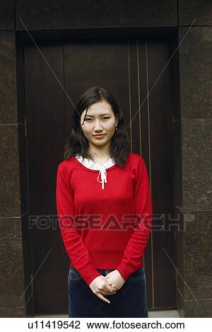 Portrait of a young woman standing View Large Photo Image Stock Image - Portrait of a young woman standing. Fotosearch