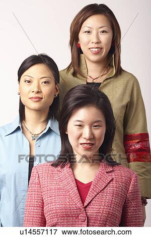Stock Photo - Portrait of three businesswomen smiling. Fotosearch
