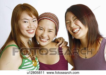 Portrait of three young women posing and smiling View Large Photo Image Stock Image - Portrait of three young women posing and smiling. Fotosearch