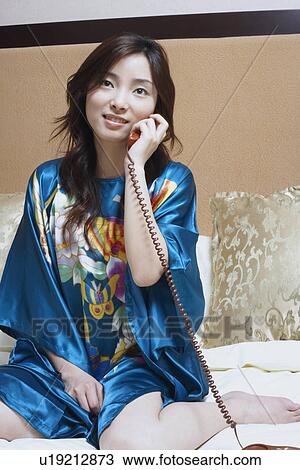 Young woman talking on the telephone View Large Photo Image Stock Image - Young woman talking on the telephone. Fotosearch